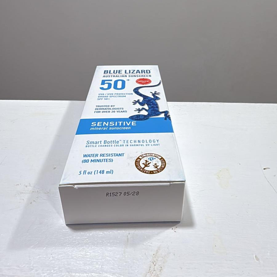 Blue Lizard SPF 50+ Sensitive Sunscreen box, 3 fl oz (140 ml), shown on a white surface against a gray background.